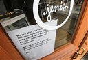 A sign on a window at a Jeni's Splendid Ice Creams states that the store is closed Friday, April 24, 2015, in Chagrin Falls, Ohio. Major recalls from two well-known ice cream companies due to the discovery of listeria bacteria raise questions about how the pathogen could have contaminated multiple ice cream manufacturing plants and whether the discoveries are related. Blue Bell Creameries of Texas and Jeni's Splendid Ice Creams of Ohio, extremely popular brands in their home states, took all their products off shelves this week. (AP Photo/Tony Dejak)