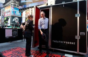 FILE - In this June 7, 2011 file photo, an audience member steps out of the "Theatre for One" performance space in New York's Times Square. Theatre for One, a 4-foot-by-8 foot portable theater, allows one audience member at a time to see one short play performed by a single actor. The theater will be parked in three Manhattan locations for the next two months, offering shows for free. Which show the audience sees is largely the luck of the draw, adding to this unique theatrical event. (AP Photo/Jason DeCrow, File)