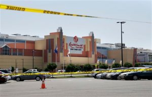 Crime scene tape remains in the parking lot near the scene of a fatal shooting in front of Resort World Casino in the borough of Queens in New York, Tuesday, May 26, 2015. The New York Police Department says a man suspected of killing his ex-girlfriend outside a casino has been shot to death by police. (AP Photo/Seth Wenig)