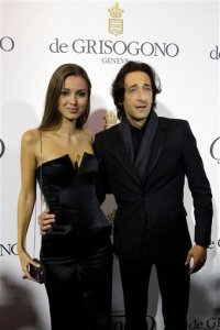 Actor Adrian Brody, right, and partner  Lara Lieto pose for photographers upon arrival for the De Grisogono party at the Hotel du Cap-Eden-Roc, on the sidelines of the 68th Cannes international film festival, Cap d'Antibes, southern France, Tuesday, May 19, 2015. (AP Photo/Thibault Camus)
