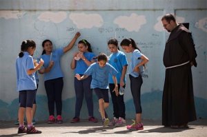 In this photo taken Tuesday, May 26, 2015, Arab Israeli Christian school children play at the Terra Santa School in the mixed Jewish-Arab city of Ramle, Israel. Private Christian schools are among Israels highest ranked educational institutions, established by churches in the Holy Land hundreds of years ago long before Israel was established. But school administrators are accusing Israel of slashing their funding as a pressure tactic to get them join the Israeli public school system a move they say would interfere with the schools Christian values and high academic achievements. (AP Photo/Oded Balilty)