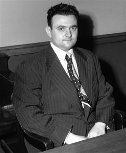 FILE- In this March 12, 1951 file photo, David Greenglass, one-time Los Alamos atom bomb project employee, is shown in Federal Court in New York in handcuffs. He testified against his sister and two others accused of passing atomic secrets to Russia. A New York judge has ordered the release of Greenglasss grand jury testimony from 1950, that may give new fuel to suspicions that his sister, Ethel Rosenberg, was unjustly convicted of espionage and put to death for conspiring to give nuclear secrets to the Soviet Union. (AP Photo/Tom Fitzsimmons, File)