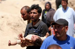 FILE - In this May 16, 2015 file photo, displaced Iraqis from Ramadi cross the Bzebiz bridge after spending the night walking towards Baghdad, as they flee their hometown, 65 km west of Baghdad, Iraq. Islamic State militants seized the center of Ramadi in western Iraq local officials said. Veterans of the Iraq War watched in frustration as Republican presidential contenders have distanced themselves from the original decision their party enthusiastically supported to invade that country. Some veterans say they long ago concluded their sacrifice was in vain, and are annoyed that a party that fervently lobbied for the war is now running from it. Other say they still believe their mission was vital, regardless of what the politicians say. And some find the gotcha question being posed to the politicians _ knowing what we know now, would you have invaded? _ an insult in itself.  (AP Photo/ Hadi Mizban, File)