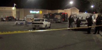 In this photo provided by WDAZ-WDAY TV Grand Forks-Fargo, police investigate the scene of a shooting at a Wal-Mart Supercenter store Tuesday, May 26, 2015, in Grand Forks, N.D. Grand Forks Police said the deadly shooting occurred a few minutes after 1 a.m. (Matt Henson/WDAZ-WDAY TV Grand Forks-Fargo via AP) MANDATORY CREDIT