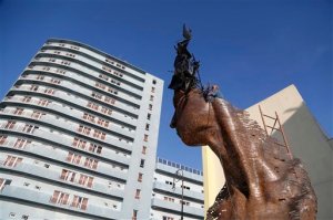 FILE - In this May 23, 2015 file photo, a worker gives the final touches to"Primavera," a creation dedicated to Cuban women, by Cuban artist Rafael San Juan in Havana, Cuba, part of the month long Havana Biennial Art Fair. The Havana Biennial art exposition wrapping up Monday, June 22 has been held 12 times since the 1980s, but this is the first one since U.S. efforts to improve relations with Cuba began six months ago. (AP Photo/Desmond Boylan, File)