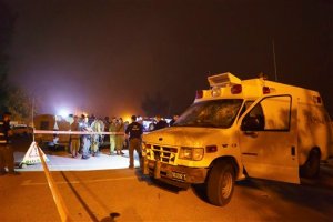 Israeli security forces stand guard around an ambulance which was attacked at the Golan Heights Tuesday, June 23, 2015. Dozens of residents of the Golan Heights attacked the ambulance late Sunday, dragging out two wounded Syrians and beating one to death. The other was evacuated to an Israeli hospital in serious condition. (AP Photo/Jinipix) ISRAEL OUT