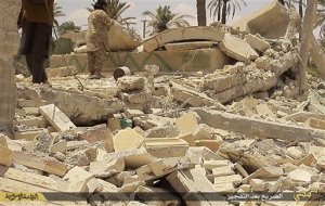 In this undated photo released on June 22, 2015, by a militant website, which has been verified and is consistent with other AP reporting, two of Islamic State militants stand on the wreckage of one of two mausoleums after blowing it up, in the historic central town of Palmyra, Syria. A Syrian official says the Islamic State group has destroyed two mausoleums in the historic central town of Palmyra. Maamoun Abdulkarim, the head of the Antiquities and Museums Department in Damascus, tells The Associated Press that one of the tombs belongs to Mohammad Bin Ali, a descendant of Islams Prophet Muhammads cousin Imam Ali. (The website of Islamic State militants via AP)