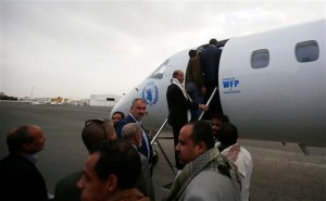 Yemeni political groups, including Shiite rebels known as Houthis, get on an airplane for Geneva for U.N.-led peace talks at the airport in Sanaa, Yemen, Sunday, June 14, 2015. The talks are slated to be first substantive meetings by all parties involved in the conflict. (AP Photo/Hani Mohammed)