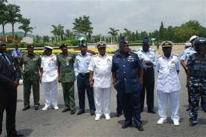 FILE - In this Monday, May. 26, 2014 file photo, Nigeria's chief of defense staff Air Marshal Alex S. Badeh, foreground third right, and other military chiefs wait to address the Nigerians Against Terrorism group during a demonstration calling on the government to rescue the kidnapped girls of the government secondary school Chibok, in Abuja, Nigeria. Nigerian military abuses caused the deaths of some 8,000 people in the fight against Boko Haram extremists, Amnesty International said Wednesday, June. 3, 2015  in a report naming senior officers it wants investigated for alleged war crimes.  (AP Photo/Olamikan Gbemiga File)