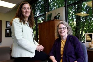 In this photo taken June 17, 2015, Dr. Pamela Miner, right, and nurse Mary Sayre pose for a photo at the Housecall Providers office in Portland, Ore.  The humble house call is being put to the test to see if it can improve care and cut costs for some of Medicare's most frail patients, and new data suggests it can work.   (AP Photo/Don Ryan)