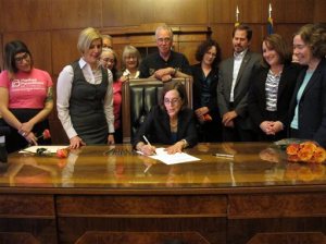 Gov. Kate Brown signs a bill expanding access to contraception during a ceremony at the state Capitol in Salem, Ore., on Thursday, June 11, 2015. The bill makes Oregon the first state to require insurers to pay for up to 12 months of birth control at a time. (AP Photo/Jonathan J. Cooper)