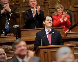 FILE - In this Feb . 3, 2015 photo, Gov. Scott Walker acknowledges applause from members of the Wisconsin State Legislature before delivering his state budget address at the state Capitol in Madison, Wis. Walker proposed, and a Republican-controlled committee later approved, eliminating tenure in state law as part of a larger overhaul of higher education policy that he is talking about to Republican voters around the country. (John Hart/Wisconsin State Journal via AP, File)