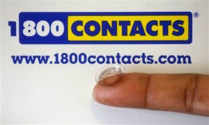 FILE - In this May 13, 2015 file photo, a contact lens is shown in front of a 1-800 Contacts shipping box in Salt Lake City. A federal appeals court will allow a hotly contested Utah law banning price fixing for contact lenses to go into effect.  The decision handed down Friday, June 12, 2015 from the 10th Circuit Court of Appeals in Denver comes after three of the nation's largest contact lens manufacturers sued to block the measure. The law could have wide-ranging effects on the roughly $4 billion contact lens market, which has some 38 million American consumers. (AP Photo/Rick Bowmer, File)