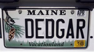 In this Thursday, May 28, 2015 photo, the license plate of a utility van dubbed "Dedgar the Poemobile" that belongs to Dead Poets Society of America founder Walter Skold is seen on  in Freeport, Maine. Skold will take the van on a 16-state, 10-week tour to document the final resting places of 90 poets in the Deep South. (AP Photo/David Sharp)