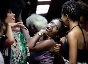 Contestants joke as they wait to walk on the catwalk during an Afro hair contest in Havana, Saturday, June 13, 2015. In a two-hour competition 70 women competed in three hair categories, natural, braided and dreadlocked. (AP Photo/Desmond Boylan)
