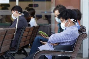 South Koreans wearing masks as a precaution against the Middle East Respiratory Syndrome virus sit at an emergency room at Seoul National University Hospital in Seoul, South Korea Monday, June 1, 2015. More than 680 people in South Korea are isolated after having contact with patients infected with a virus that has killed hundreds of people in the Middle East, health officials said Monday. (AP Photo/Ahn Young-joon)