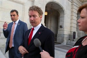 Sen. Rand Paul, R-Ky., talks with a reporter as he leaves the Capitol following his address to the Senate in Washington, Sunday, May 31, 2015. The Senate was unable to make a deal to extend contested anti-terror provisions and as a result, the post-Sept. 11 programs expired at midnight Sunday.   (AP Photo/Cliff Owen)