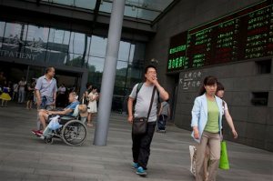 A man smokes as he walks out from the Peking Union Medical College Hospital in Beijing, China Monday, June 1, 2015. China's capital Monday began imposing the country's toughest ban on indoor smoking in hopes of stemming a looming health crisis. (AP Photo/Andy Wong)