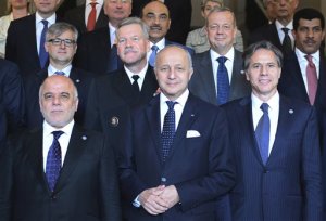 First row from left : Iraqi Prime Minister Haider al-Abadi, French Foreign Affairs Minister Laurent Fabius and US Deputy Secretary of State Antony J. Blinken pose for a group photo with Foreign Affairs ministers and members of the anti-Islamic State coalition after a meeting in Paris, France, to discuss strategy in fighting the jihadist militant group, who have made key battlefield advances in recent weeks in Iraq and Syria, Tuesday, June 2, 2015. Iraqs prime minister and international allies are gathering in Paris to re-examine their strategy against Islamic State extremists, after the groups recent gains. The coalition, which includes the United States and France but not Russia, Iran or Syria, is meeting Tuesday after extremists conquered both the Iraqi city of Ramadi and the historic Syrian city of Palmyra. (Stephane de Sakutin/Pool Photo via AP)