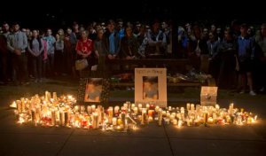 Mourners stand by during a candlelight vigil for six Irish students Wednesday, June 17, 2015, in Berkeley, Calif. The six Irish students died when a balcony collapsed during a party. (AP Photo/Beck Diefenbach)