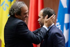 FILE - In this Friday, May 29, 2015, file photo, Prince Ali bin al-Hussein, right, is embraced by  UEFA President Michel Platini, left, after al-Hussein announced his withdrawal in the FIFA president election at the 65th FIFA Congress at the Hallenstadion in Zurich, Switzerland. European soccer leader and former French star Michel Platini and Jordan's Prince Ali bin al-Hussein are the likely candidates to succeed Sepp Blatter. But in an election where Africa and Asia hold almost half the votes, Cameroon's Issa Hayatou and others may enter the race. (Walter Bieri/Keystone via AP, File)