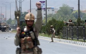 Afghan security forces run at the site of a suicide attack during clashes with Taliban fighters in front of the Parliament, in Kabul, Afghanistan, Monday, June 22, 2015. The Taliban launched a complex attack on the Afghan parliament Monday, with a suicide car bomber striking at the entrance and gunmen battling police as lawmakers were meeting inside to confirm the appointment of a defense minister, police and witnesses said. (AP Photo/Massoud Hossaini)