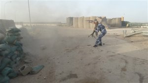 In this Thursday, June 4, 2015 photo, Iraqi Federal police and Shiite Hezbollah Brigade militiamen fight against the Islamic State group as they defend their positions on the front line in eastern Husaybah, 8 kilometers (5 miles) east of Ramadi, Iraq. (AP Photo)