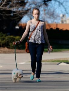 In this April 2015 photo, sexual assault victim Emily Kollaritsch is shown with her service dog, Candy, in East Lansing, Mich. If it weren't for Candy, Kollaritsch, who suffers from post-traumatic stress disorder, says she would not have been able to return to school. A growing backlog at the U.S. Department of Education has some sexual assault victims waiting years to have their cases resolved. (AP Photo/Al Goldis)