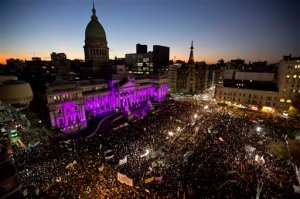FILE - In this June 3, 2015 file photo, people demonstrate against gender violence outside the National Congress in Buenos Aires, Argentina. There are many contradictions in Argentina when it comes to gender equality. Women have equal rights under the law and there are more women than men enrolled in college. The countrys most powerful person is a woman _ President Cristina Fernandez. But the macho culture of many Latin American countries is pervasive here as well. (AP Photo/Natacha Pisarenko, File)