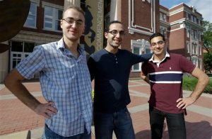 Syrian brothers Mohammad Kayali, left, Ebrahim Kayali, right and Molham Kayali, center, pose for a photograph on the Emporia State University campus in Emporia, Kan., Wednesday, May 6, 2015.   Tens of thousands of college students in Syria have been displaced by the long-running conflict, creating an educational vacuum that colleges around the world are increasingly seeking to fill in the hopes that the academic refugees will someday help rebuild their country. Brothers, Molham, Mohammad and Ebrahim Kayali all landed at Emporia State University in Kansas and are emblematic of the plight and are among the 700 Syrian students in the U.S. (AP Photo/Orlin Wagner)