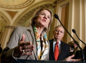 FILE - In this Jan. 20, 2015 file photo, Sen. Shelley Moore Capito, R-W.Va., accompanied by Senate Majority Leader Mitch McConnell of Ky., speaks during a news conference on Capitol Hill in Washington. Senate Republicans discussed a proposal Wednesday to temporarily help millions of people who could lose federal health care subsidies should the Supreme Court annul the aid, which has been a pillar of President Barack Obamas health care law. (AP Photo/J. Scott Applewhite, File)