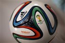FILE - This May 8, 2014 file photo shows the Adidas logo on "Brazuca", the official FIFA World Cup 2014 soccer ball, during the annual shareholders meeting in Fuerth, Germany. With billions of dollars at stake and few other ways to tap into the global love of soccer, FIFA sponsors like Adidas, Coke and McDonalds are likely to hang onto their marketing deals and try to weather the scandal that has tarnished soccers governing body. (AP Photo/Matthias Schrader, File)
