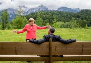 German Chancellor Angela Merkel speaks with U.S. President Barack Obama at Schloss Elmau hotel near Garmisch-Partenkirchen, Germany, Monday, June 8, 2015, during the G-7 summit. (Michael Kappeler/Pool Photo via AP)