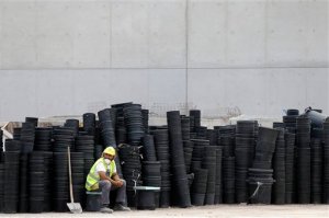 A worker takes a break at the construction site of the Stavros Niarchos Culture Center where the new opera house and national library will be completed in 2016, in southern Athens, on Monday, June 8, 2015. The 566-million euro project is one of the country's few privately funded projects since the country was struck by a major financial crisis in 2009. Greek negotiators are in Brussels to explore the "scope for convergence" with the country's creditors, following days of acrimony over rival reform proposals for a deal that will unlock Greece's last remaining bailout funds. (AP Photo/Thanassis Stavrakis)
