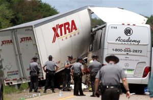 Authorities investigate the scene of a fatal collision between a tractor-trailer and a tour bus on Interstate 380 near Tobyhanna, Pa., Wednesday, June 3, 2015. Multiple people were killed and more than a dozen were sent to hospitals. (Jake Danna Stevens/The Times & Tribune via AP)