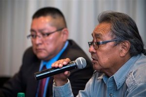 Leigh Kuwanwisiwma, right, director of the Hopi Tribe's Cultural Preservation Office, answers a question during a news conference on the Paris auctions selling Hopi sacred objects as Hopi Chief Ranger Ronald Honyumptewa looks on Wednesday, May 27, 2015 at the Heard Museum in Phoenix. Hopi tribal leaders and Arizonas members of Congress are asking U.S. law enforcement to stop the sale of about a dozen sacred Hopi artifacts at a Paris auction house in June.  (Mark Henle/The Arizona Republic via AP)  MARICOPA COUNTY OUT; MAGS OUT; NO SALES; MANDATORY CREDIT