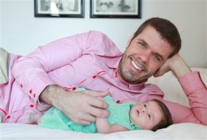 This Sunday, June 7, 2015 photo shows Perez Hilton and his new daughter Mia posing for a portrait at the Sofitel, in New York. Hiltons first Fathers Day with his baby girl will be on Sunday, June 21. The 37-year-old celebrity blogger (real name: Mario Lavanderia) started his family in 2013 when son Mario was born via surrogate. (Photo by Amy Sussman/Invision/AP)