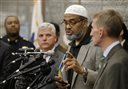 Abdullah Faaruuq, Imam of the Mosque for the Praising of Allah, in Boston, center right, speaks to reporters during a news conference as Suffolk County District Attorney Dan Conley, center left, and Boston Police Commissioner William Evans, right, look on during a news conference, Wednesday, June 3, 2015, at Boston Police Headquarters, in Boston. Boston police said they have video showing Usaama Rahim, a man who was under 24-hour surveillance by terrorism investigators, lunging with a knife at a police officer and an FBI agent before he was shot and killed. (AP Photo/Steven Senne)