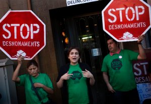 In this Monday Oct. 3, 2011 photo, leading Spanish social activist Ada Colau, center, who beat the candidate of the Catalonia region's long-dominant conservative Convergence and Union party in Sunday's local elections in Spain, speaks to activists of her platform during a protest to halt an eviction in Barcelona, Spain. Colau says the fight against evictions, poverty and corruption will be her priority as new mayor of the country's second city, Barcelona.  (AP Photo/Emilio Morenatti)