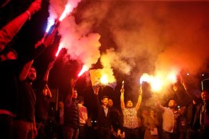 Supporters of Turkey's ruling Justice and Development Party celebrate after the election results came out in Istanbul,Turkey, late Sunday, June 7, 2015. With 99.9 percent of the vote counted, Erdogan's AKP had the support of around 41 percent of voters, state-run TRT television said. (AP Photo/Emrah Gurel)