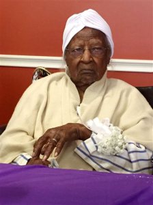 FILE - In this Thursday, May 21, 2015 file photo, Jeralean Talley, born on May 23, 1899, is honored at the Inkster, Mich. district office of the Michigan Department of Health and Human Services. Jeralean Talley, a 116-year-old woman deemed the world's oldest person, died Wednesday, June 17, 2015 at her home in the Detroit suburb of Inkster. The Gerontology Research Group considered Talley to be the world's oldest person, based on available records,  (Elisha Anderson/Detroit Free Press via AP, File)