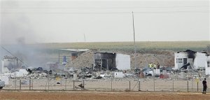 Police officers and firefighters stand by the destroyed fireworks factory Pirotecnia Zaragozana's building after a huge explosion in Pinseque, Spain, Monday, Aug. 31, 2015. The blast at a fireworks factory in northeastern Spain killed a number of people and seriously injured tothers, police and firefighters didn't know the cause of the blast. (AP Photo/Aranzazu Navarro)