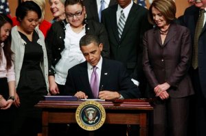 FILE - In this March 30, 2010 file photo, President Barack Obama signs the Health Care and Education Reconciliation Act of 2010 in a ceremony at Northern Virginia Community College in Alexandria, Va. Nearly a million people signed up for health insurance under President Barack Obama's law even after the official enrollment season ended, helping push the share of uninsured Americans below 10 percent and underscoring how hard it could be for Republicans to dismantle the program. (AP Photo/Pablo Martinez Monsivais, File)