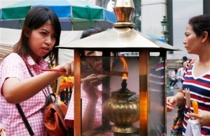 In this Aug. 26, 2015, file photo, worshippers light sticks of incense at the Erawan Shrine at Rajprasong intersection, in Bangkok, Thailand. Thai police probing Bangkok's deadly bombing said on Monday, Aug. 31, 2015, that they have discovered bomb-making materials during a raid of a second apartment on the outskirts of the capital. (AP Photo/Penny Yi Wang, File)
