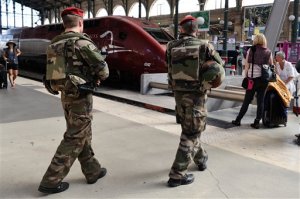 FILE - In this Aug .22 2015 file photo, French soldiers patrol at Gare du Nord train station in Paris, France. The attack Aug. 21 on the Thalys train from Amsterdam to Paris happened at the height of the summer travel season. France hosts emergency talks in Paris on Saturday, with representatives from other high-speed international rail nations, Belgium, Britain, Germany, Italy, Luxembourg, the Netherlands, Spain and Switzerland. (AP Photo/Binta, File)