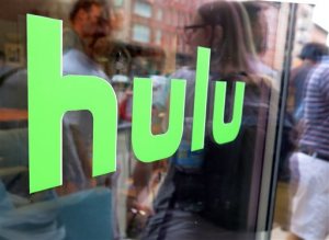 This Saturday, June 27, 2015 photo shows the Hulu logo on a window at the Milk Studios space in New York, where a replica of the "Seinfeld" set was on display, in New York. The cable network Epix jumped from Netflix to Hulu, the companies announced late Sunday, Aug. 30, 2015, landing a multiyear, digital subscription video on demand deal with the streaming service. (AP Photo/Dan Goodman)