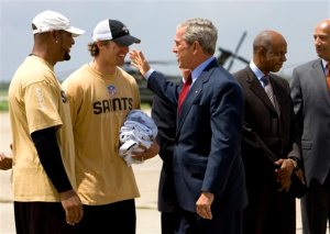 FILE - In this Aug. 8, 2008, file photo, President George W. Bush is met by Deuce McAllister, left, and Drew Brees of the New Orleans Saints football team as he arrives at Louis Armstrong New Orleans International Airport on the way to events marking the third anniversary of Hurricane Katrina, in Kenner, La. At far right is New Orleans Mayor Ray Nagin, second from right is Rep. William Jefferson, D-La. The 10-year anniversary of one of the most devastating hurricanes in U.S. history is a time of reflection for many connected to the Saints, whose return to New Orleans in 2006, following one season of displacement to San Antonio, became one of the ultimate feel-good stories in NFL history. (AP Photo/J. Scott Applewhite, File)