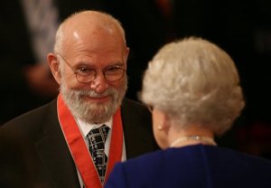 FILE - This is a  Nov. 26, 2008 file photo of  Dr Oliver Sacks, receiving his Commander of the Order of the British Empire (CBE ), by  Britain's Queen Elizabeth II at Buckingham Palace, London. Dr. Oliver Sacks, whose books like "The Man Who Mistook His Wife For a Hat" probed distant ranges of human experience by compassionately portraying people with severe and sometimes bizarre neurological conditions, has died. He was 82 .Sacks died Sunday at his home in New York City, his assistant, Kate Edgar, said. (Lewis Whyld/PA via AP) UNITED KINGDOM OUT  NO SALES NO ARCHIVE