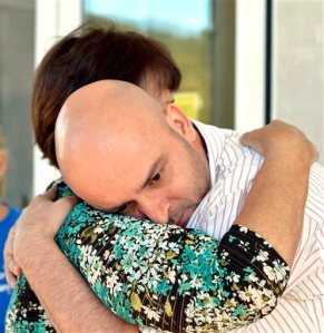 William Smith Jr., right, and Mary Hargis embrace outside the Rowan County Courthouse in Morehead, Ky., Thursday, Aug. 27, 2015. Smith, and his partner, James Yates, were denied a marriage license for the third time despite the ruling of the 6th U.S. Circuit Court of Appeals, upholding an earlier decision instructing the clerks to issue marriage licenses. (AP Photo/Timothy D. Easley)