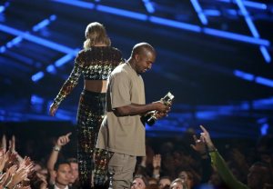 Taylor Swift, background, exits the stage after presenting the video vanguard award to Kanye West at the MTV Video Music Awards at the Microsoft Theater on Sunday, Aug. 30, 2015, in Los Angeles. (Photo by Matt Sayles/Invision/AP)